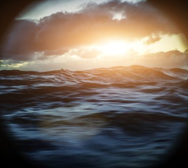From the porthole window of a vessel in a rough sea